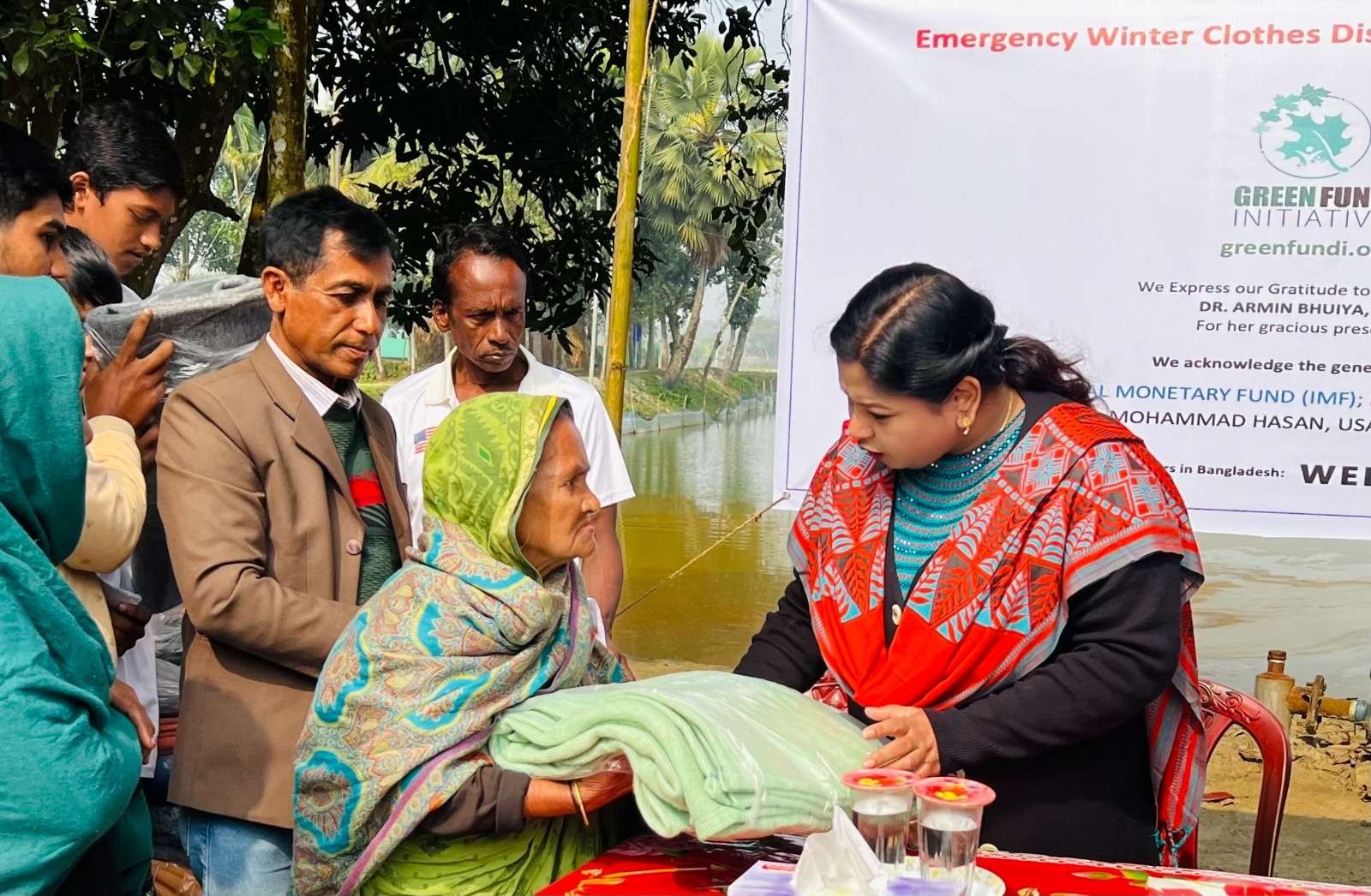 An elderly woman receiving warm clothes at a GFI emergency winter clothes distribution