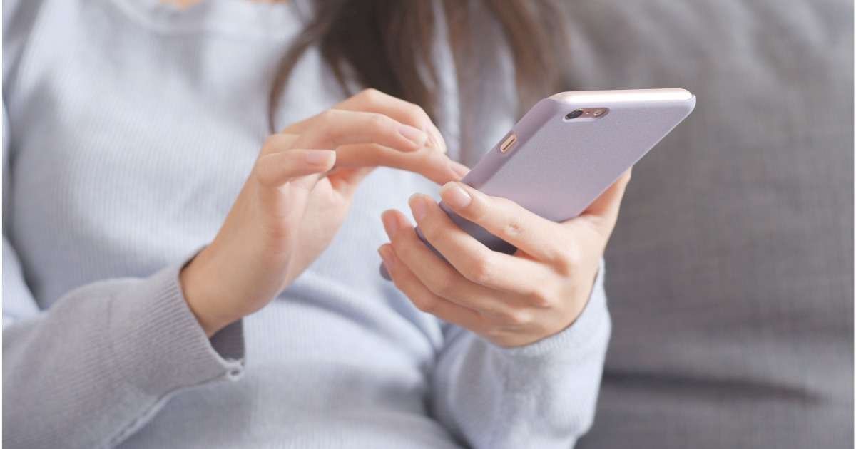 A person typing a message on a smartphone