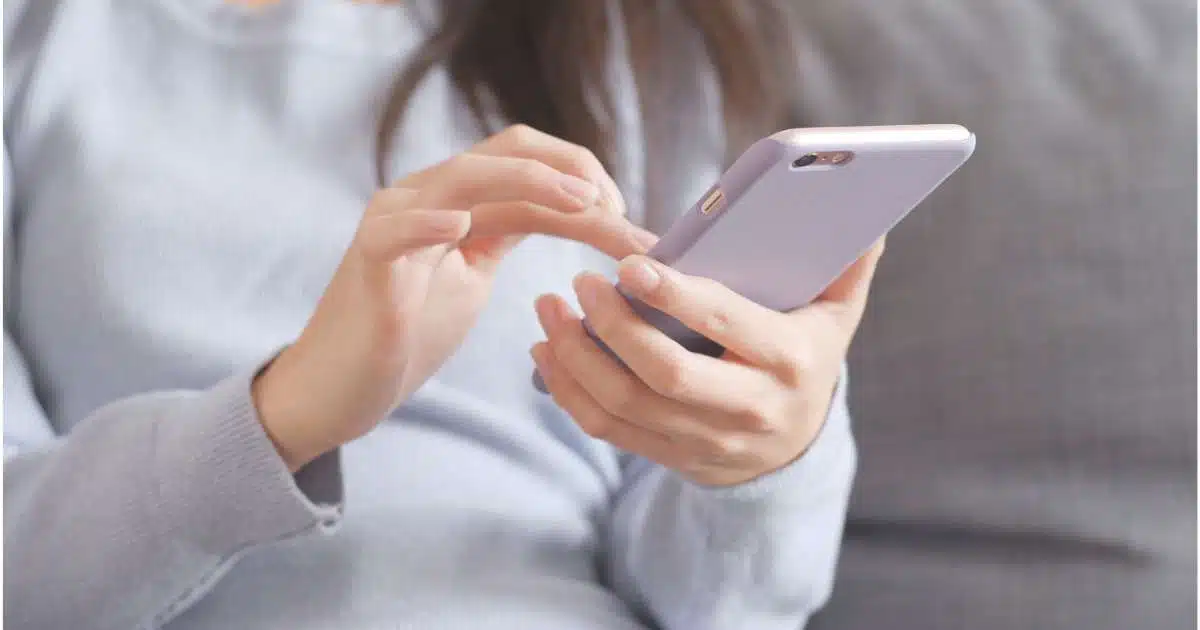 A person typing a message on a smartphone