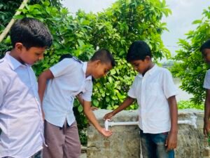 Schoolchildren drinking and washing their hands at the newly installed water facility in Netrokona.